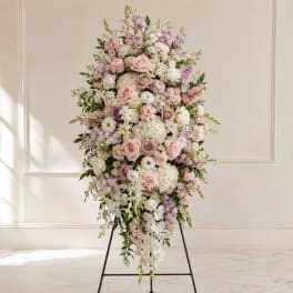 Tall pastel floral standing spray on an easel