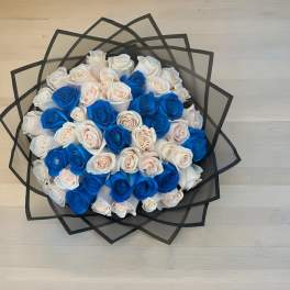 Bouquet of blue and white roses wrapped in black paper