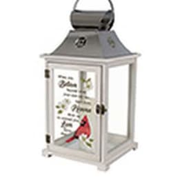 Decorative white lantern with a cardinal and text on the glass panel