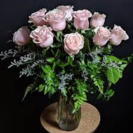 Pink roses arranged in a clear glass vase