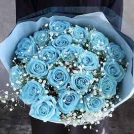 Bouquet of bright blue roses with white baby's breath