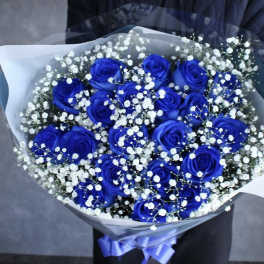 Bouquet of blue roses with white baby's breath in clear wrap
