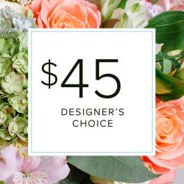 Designer’s choice floral arrangement with peach roses and pale green hydrangea