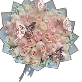Bouquet of pale pink roses with butterfly decorations