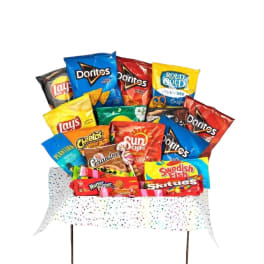 Assorted snack bags arranged in a gift display with speckled wrap