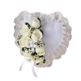 Heart-shaped lace frame with white roses and ribbon