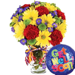 Bouquet of yellow, red, and purple flowers in a glass vase with a Get Well Soon balloon