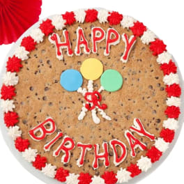 Birthday cookie cake with red and white icing and balloon decorations