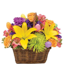 Colorful flower basket with yellow lilies and orange roses