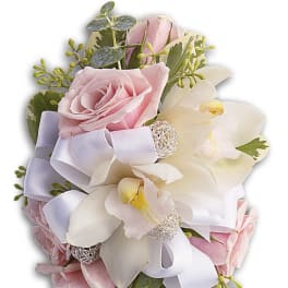 Pink roses and white orchids arranged with a lavender ribbon