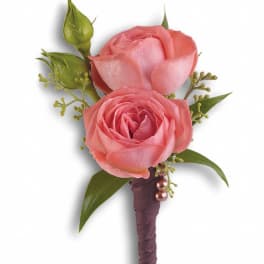 Pink rose boutonniere with green buds and ribbon-wrapped stem