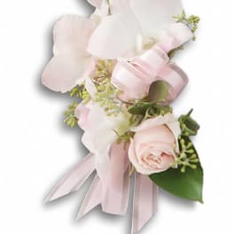 Pink and white floral corsage with ribbon ties