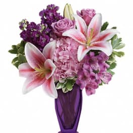 Pink lilies and roses in a purple vase