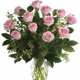 Pink roses arranged in a clear glass vase