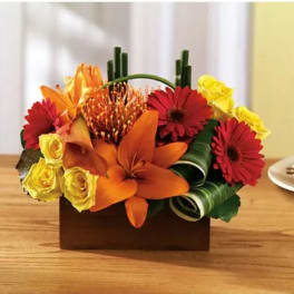 Colorful floral arrangement in a rectangular wooden container