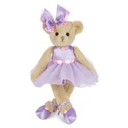 Teddy bear in a lavender dress and bow