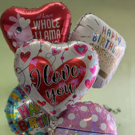 Cluster of birthday and love-themed foil balloons