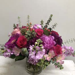 Pink and purple mixed bouquet in a glass vase