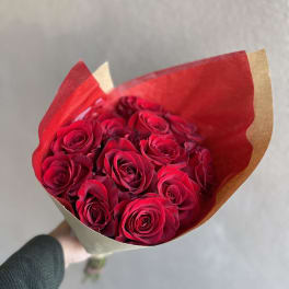 Bouquet of red roses wrapped in red and kraft paper