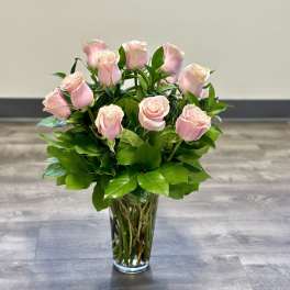 Pink roses arranged in a clear glass vase