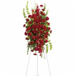 Tall red floral standing spray on a metal easel