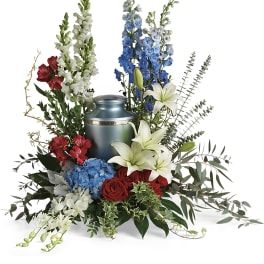 Sympathy urn arrangement with red, white, and blue flowers