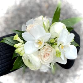 White orchid and rose wrist corsage with green accents