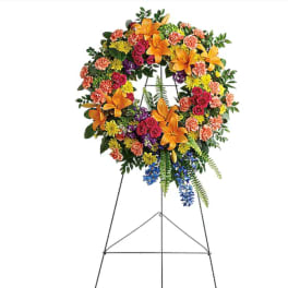 Colorful standing floral wreath on a metal easel