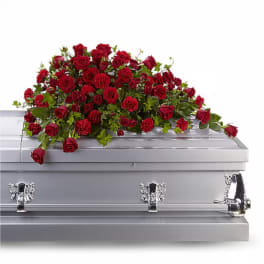 Red rose casket spray on a gray casket