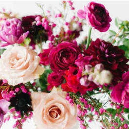 Bouquet of pink, burgundy, and cream flowers with mixed blooms