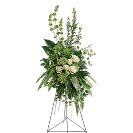 Tall white rose and greenery standing spray on an easel