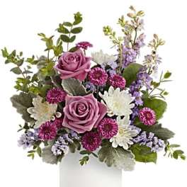 Pink roses and purple-white flowers in a white vase