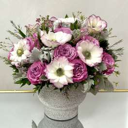 Pink and white roses with white anemones in a textured vase