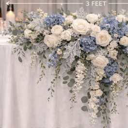 White and blue floral garland draped over a table