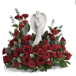 Red rose arrangement with an angel statue centerpiece