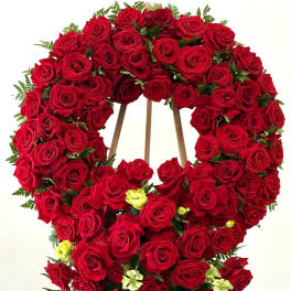 Large red rose funeral wreath on a wooden easel