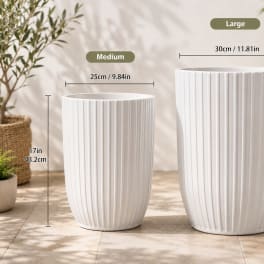 Two white ribbed ceramic planters in different sizes