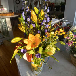 Colorful bouquet with lilies and purple flowers in a decorative vase