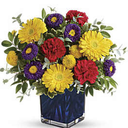 Bouquet of yellow, purple, and red flowers in a blue vase