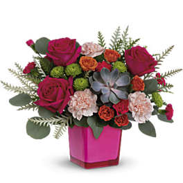 Pink roses and carnations arranged in a magenta vase