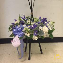 Floral arrangement on a golf-club stand with purple and white flowers