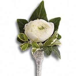 White flower boutonniere with green leaves and silver-wrapped stem