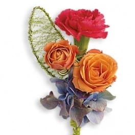 Boutonniere with orange roses, a pink carnation, and blue hydrangea