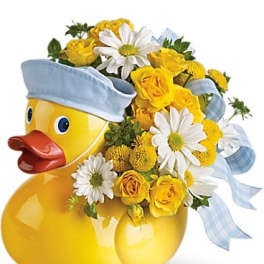 Yellow duck-shaped vase with yellow roses and white daisies