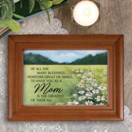 Framed Mother’s Day plaque with daisies and a candle nearby
