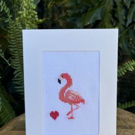 Flamingo cross-stitch card on a clear stand