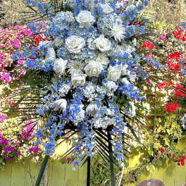 Tall standing floral spray with white roses and blue flowers