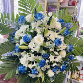 Large blue and white floral spray with palm leaves