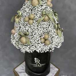 White baby's breath arrangement with gold ornaments and green bows in a black box