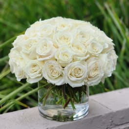 White rose bouquet in a clear glass vase